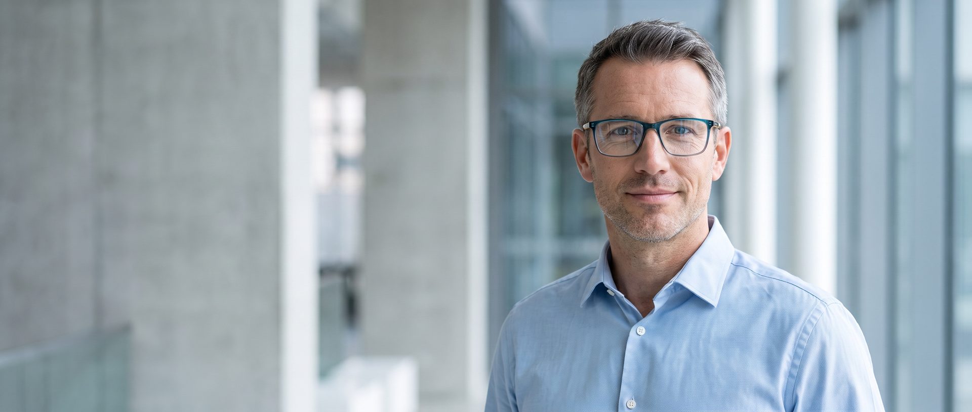 Man in a modern building wearing Guy Laroche optical frames
